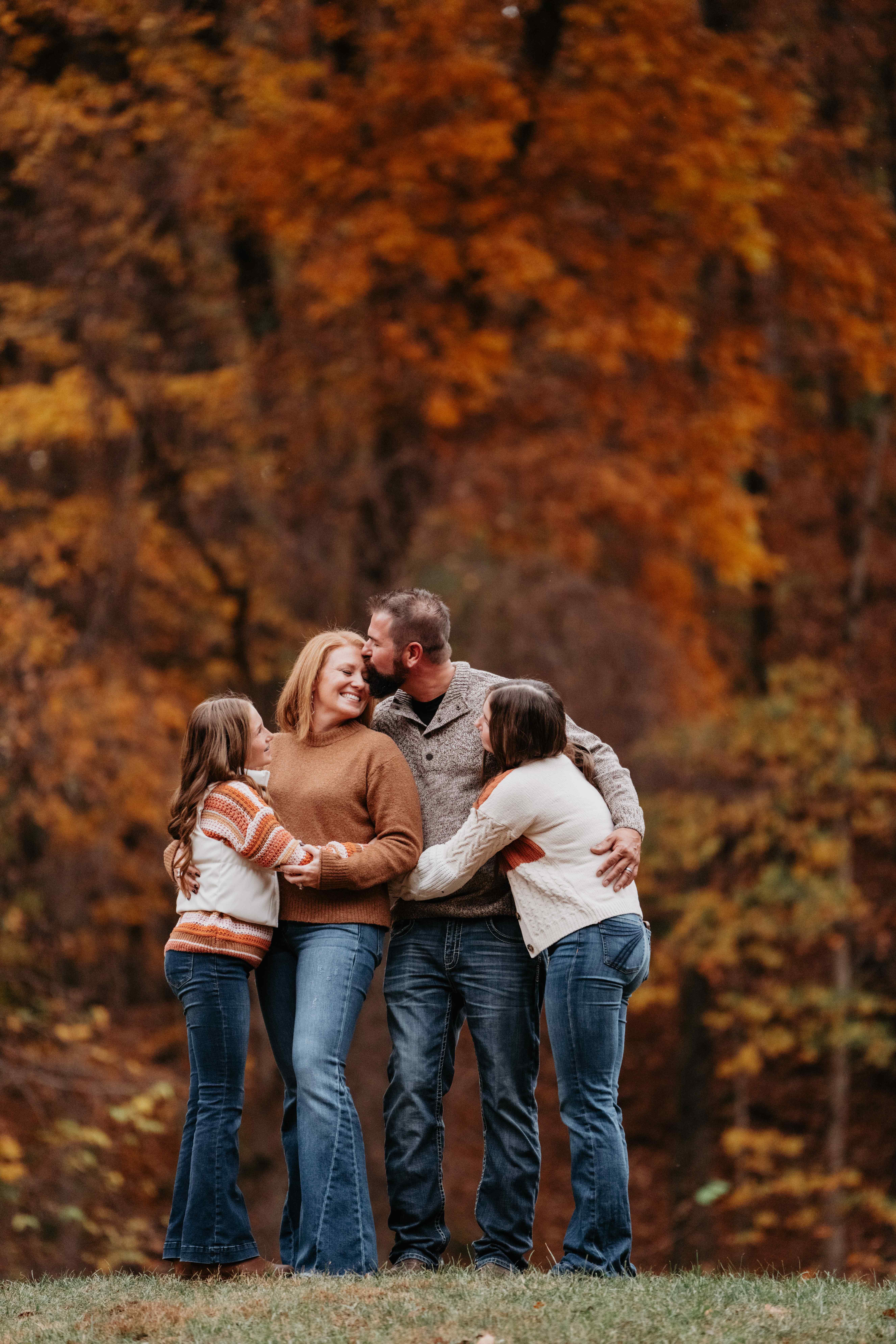 Lafayette family photographer - family embracing outdoors with autumn foliage